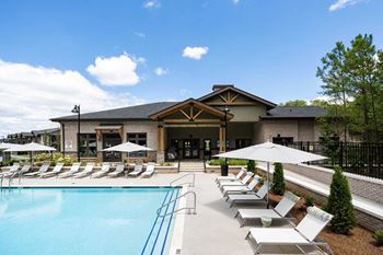 Modern pool with outdoor gas grilling station and fire pit